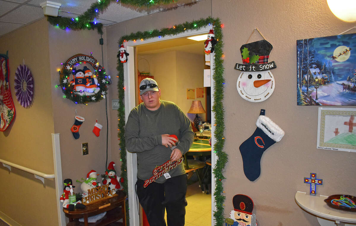 Jason Parisi leaves his room at Balsam Terrace and Spruce Manor after retrieving a Christmas decoration from his room. Parisi, who is deaf and blind, does all the seasonal decorating at the apartment complex in Jacksonville.