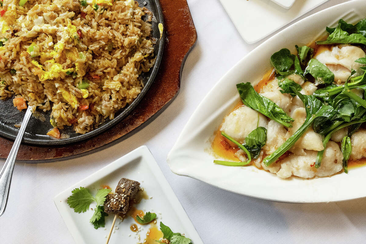 (Left clockwise) House Sizzling Fried Rice, 5 Spice White fish, and Crispy Honey Chili Short Rib at Fang in San Francisco CA. Dec. 6, 2022