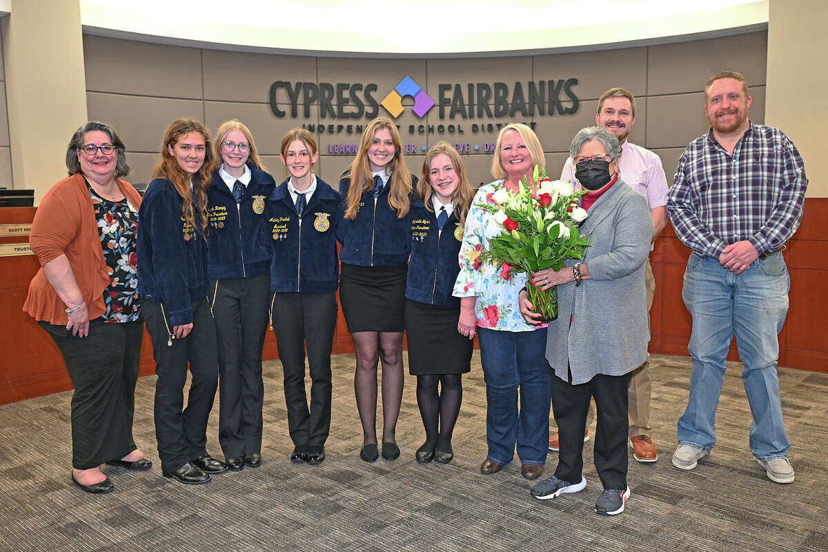 Darlene Jarrar, fourth from right, and Board Trustee Debbie Blackshear, third from right, join agricultural education students and staff from Cypress Falls and Cypress Woods high schools and CTE Director Denise Kubecka, far left, at the Dec. 12 Board of Trustees meeting. The Board unanimously voted to approve the namesake for the Mike & Darlene Jarrar Arena at the CFISD Exhibit Center. 