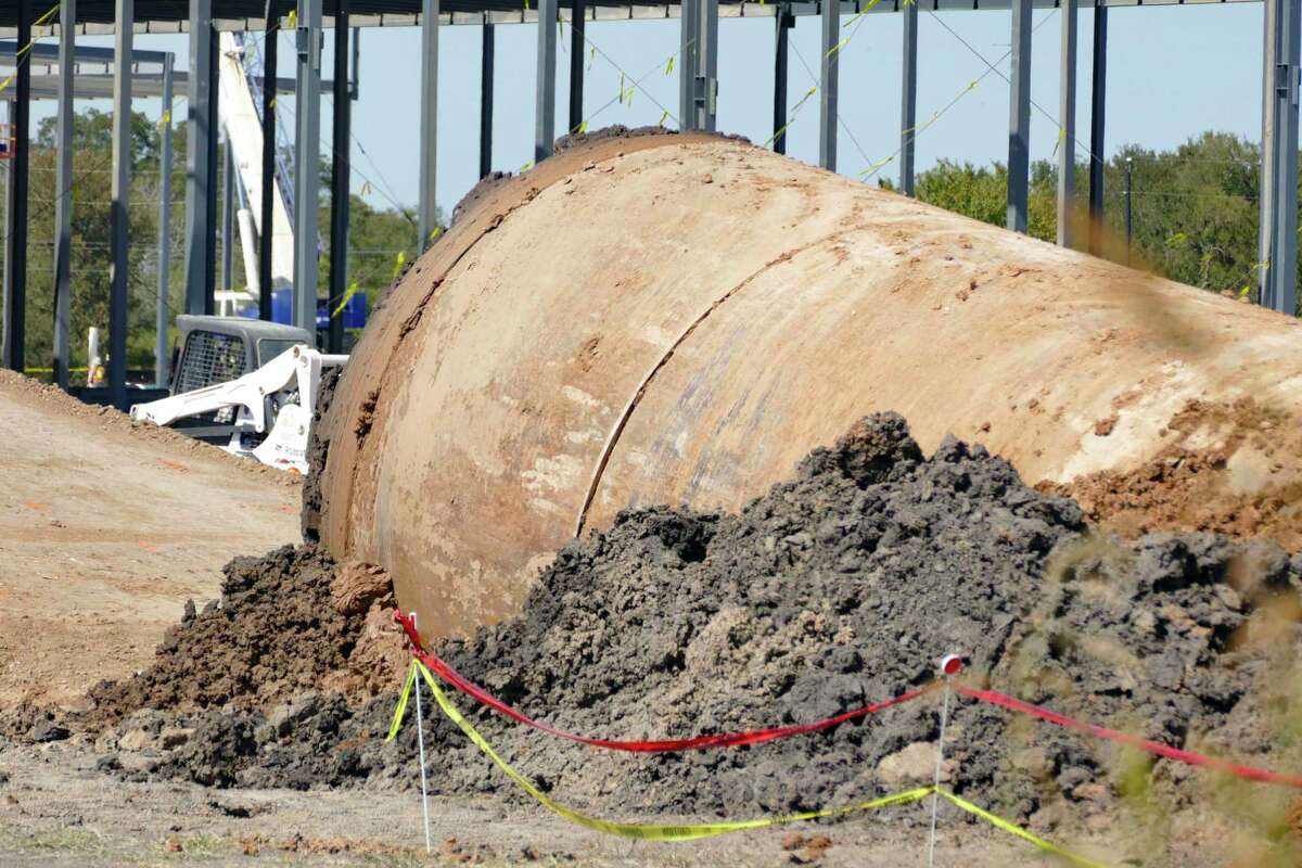 Dirt pours out of the end of a large pipe at The Boring Co. facility in Bastrop, Texas, on Tuesday, Oct. 4, 2022. The Elon Musk-owned Boring Co. builds tunnels for transportation loops and other purposes.