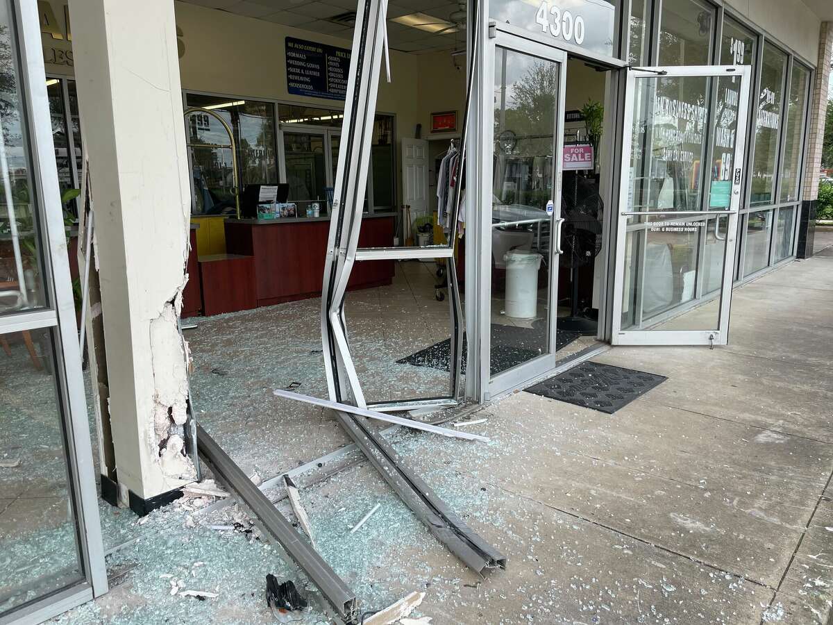 The car that went through the front of this Farmont Parkway store Friday morning had just been removed, leaving behind a big mess.