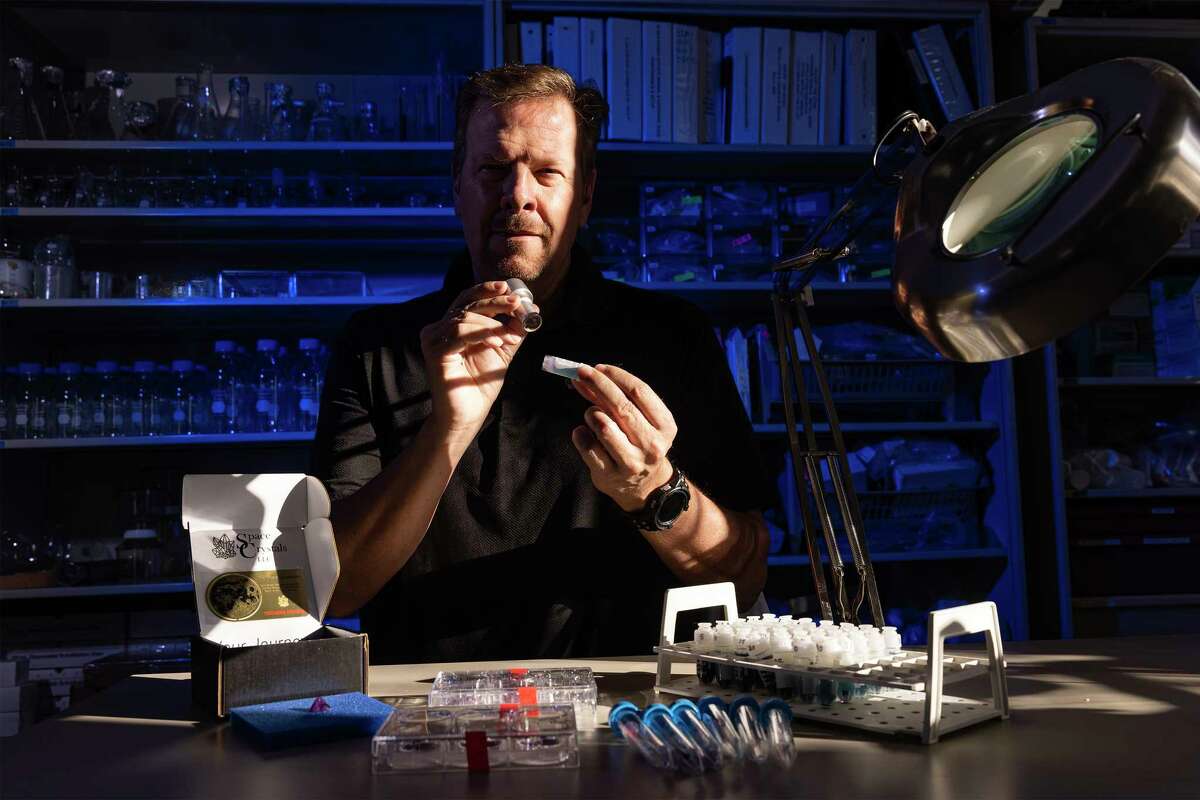 12/16/22 Houston, TX: USA: Kevin Heath who founded founded a company called Space Crystals looks at the crystal inside a capsule through a loupe. The crystal has been to the space station. For $150,000, a customer's DNA is launched into space and grown into two crystals. These crystals return home; one is given to the customer and then the other is sent to the moon. Heath said “we believe the two DNA-infused space crystals we create for our clients have a spiritual – almost mystical – connection that will be shared through time and space. So, every night when you look up at the moon you will know – and feel – that a part of you is up there. We call it the Crystal Connection.’”