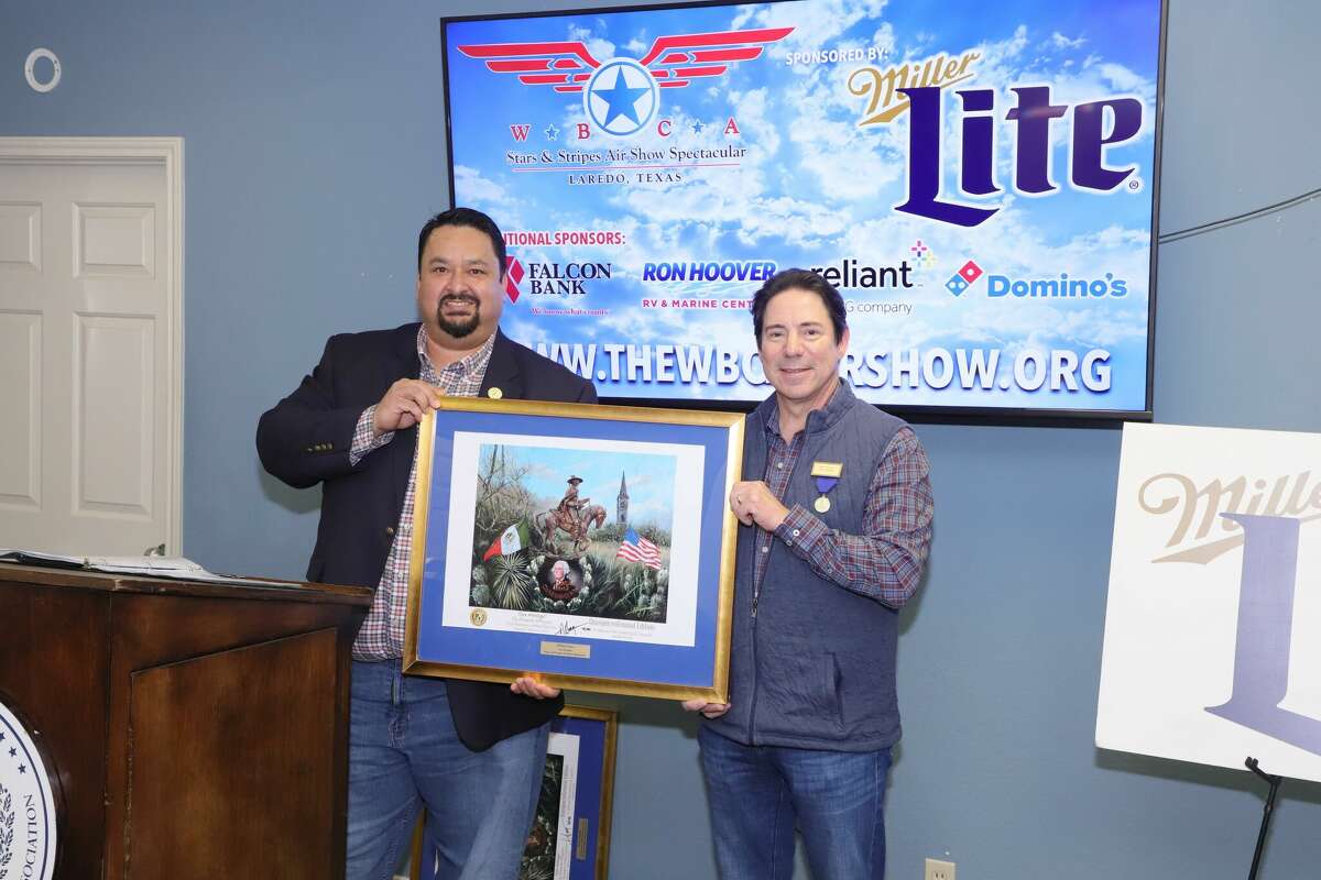 From Left to Right Vice President of Southern Distributing Company, Kiko Treviño; WBCA 2nd Vice-President Jaime Fuentes pose with the official 125th Celebration’s Commemorative poster during the WBCA Stars & Stripes Air Show Spectacular Sponsored by Miller Lite  lineup announcement at the WBCA office on Friday, Dec.16, 2022.