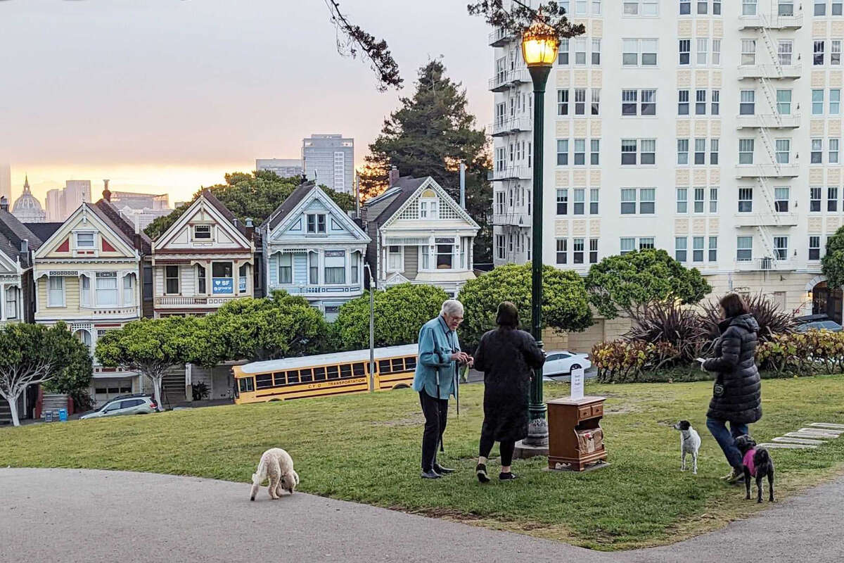 Passersby in Alamo Square check out Amanda Barrows' poetry nightstand, a field project for her Poetry for the People course at City College of San Francisco.