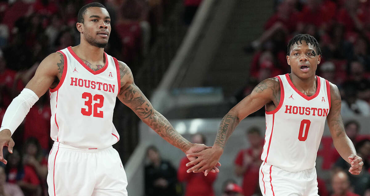Houston Cougars forward Reggie Chaney (32) and guard Marcus Sasser (0) congratulates each other after scoring in the second half at the Fertitta Center on Tuesday, Dec. 13, 2022 in Houston. Houston Cougars won the game 74-46.