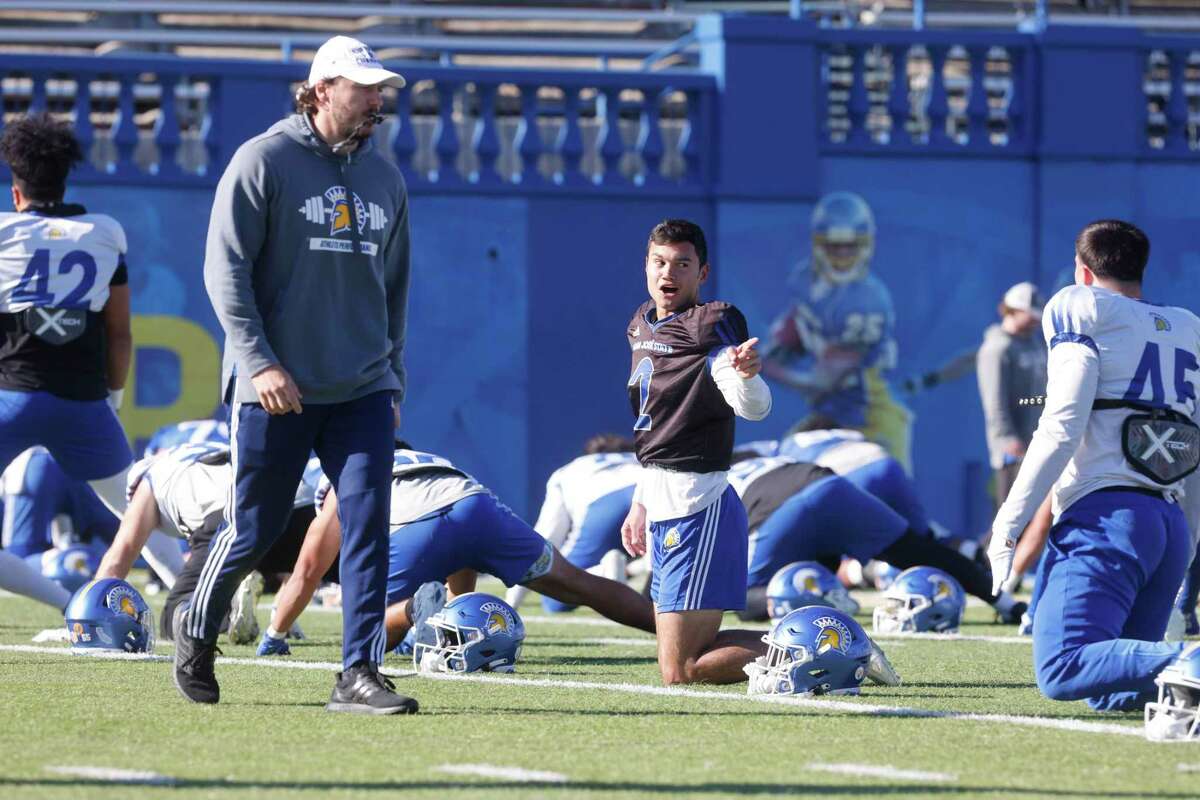 San Jose State quarterback Chevan Cordeiro talks with a teamate as they stretch during football practice at CEFCU stadium on Friday, December 10, 2022 in San Jose, Calif.