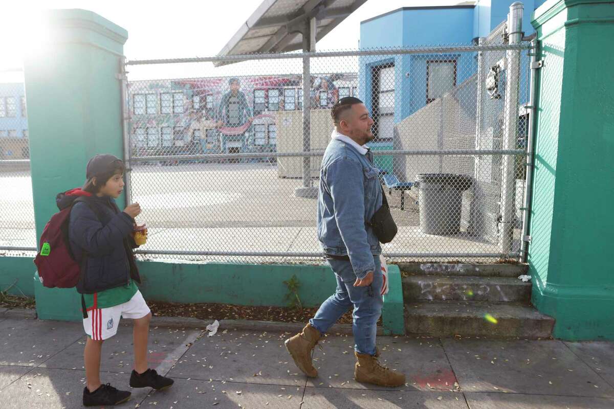 Jonathan Sanchez and son Necalli Anam Sanchez head to the Mission Recreation Center in San Francisco to play soccer.