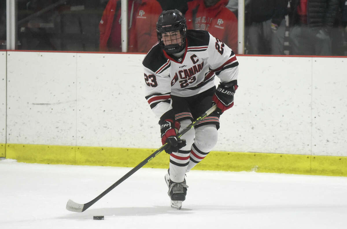 New Canaan's Doster Crowell (23) lines up a shot against Fairfield Prep during a boys ice hockey game at the Darien Ice House on Friday, Dec. 16, 2022.