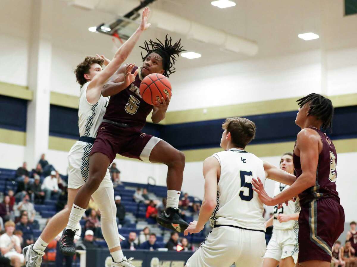 Magnolia West's Elijah Portalis (5) draws pressure against Lake Creek's Jett Sutton (1) as he goes ups for a basket in the second quarter of a District 21-5A high school basketball game at Lake Creek High School, Friday, Dec. 16, 2022, in Montgomery.