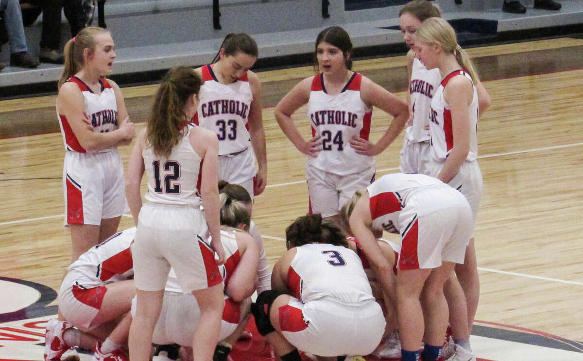 The Manistee Catholic Central girls basketball team goes through its pregame ritual before a game against Bear Lake on Dec. 16, 2022 at Manistee Catholic Central.