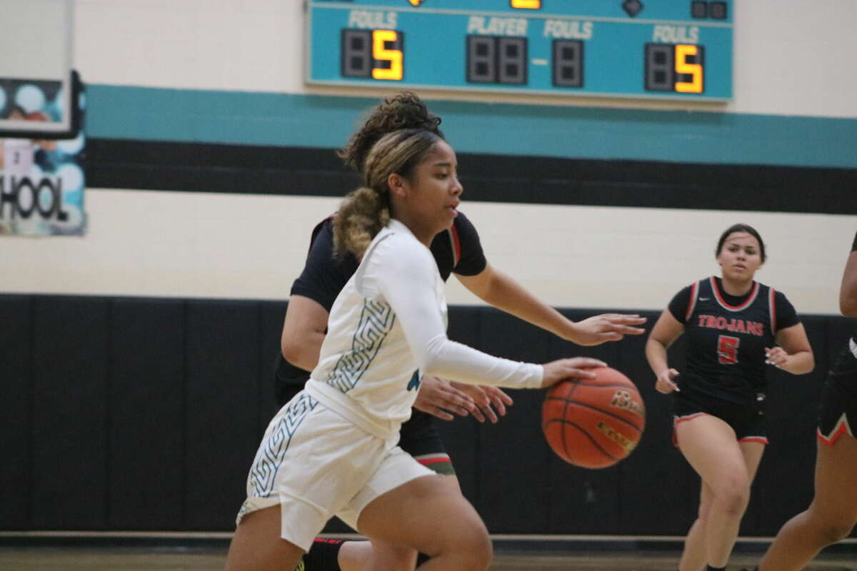 Memorial freshman Dayami Reyes hustles up court against the Lady Trojan defense Tuesday. The Lady Mavs gave their bench plenty of quality minutes in the 35-point victory.