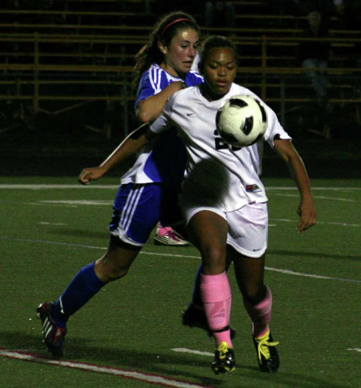 Ludlowe's Gabby Rudolph battles Trumbull's Taylor Pratcher for the ball in the Falcons' 0-0 tie with the Eagles on Monday night at Trumbull High School.