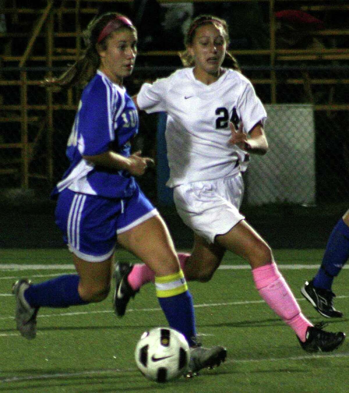 Fairfield Ludlowe's Mary Kamovitch dribbles the ball passed Melissa Rulotini during the Falcons' 0-0 tie with Trumbull on Monday in Trumbull.