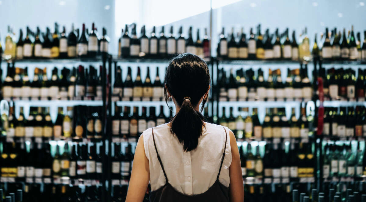 Woman buying wine 