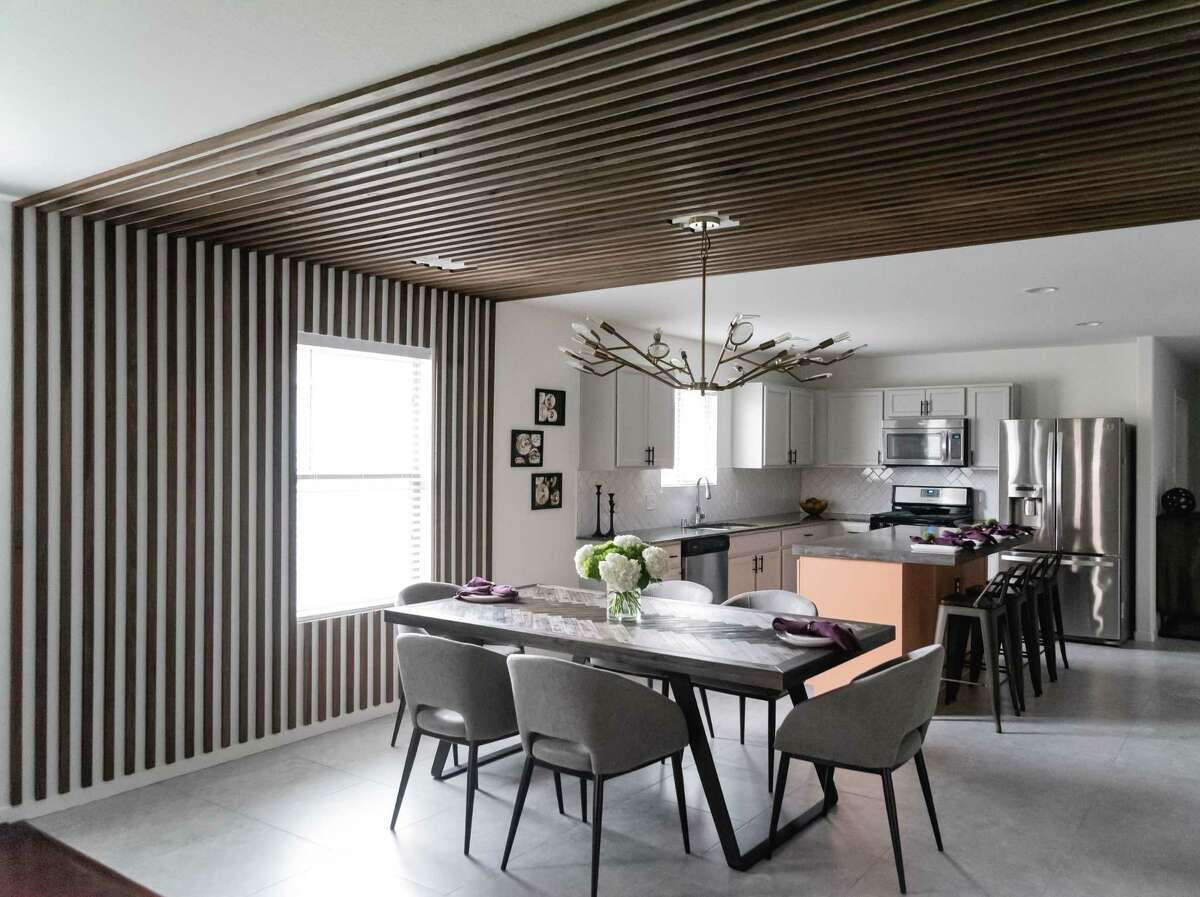 Strips of wood that run up an outside wall and across the ceiling add warmth to Trent Johnson's new dining area.