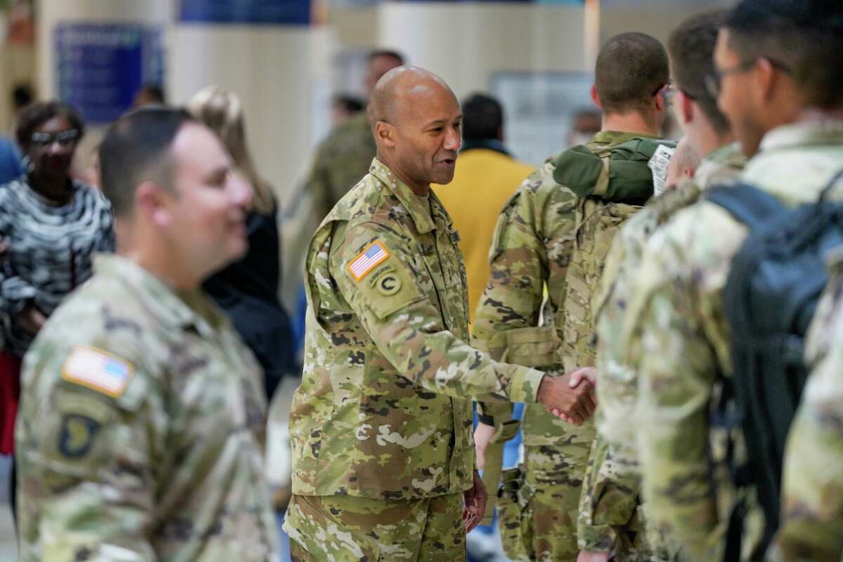 Maj. Gen. Michael Talley greets soldiers at San Antonio International Airport Saturday morning. Some 4,000 of them are heading home for the holidays, an annual ritual known as Exodus.