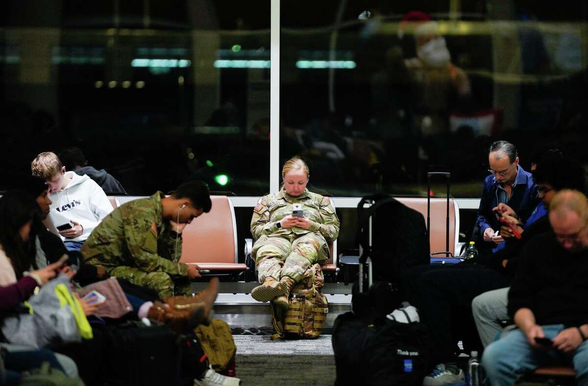 Soldiers wait for flights at San Antonio International Airport Saturday morning. Some 4,000 of them are heading home for the holidays, an annual ritual known as Exodus.