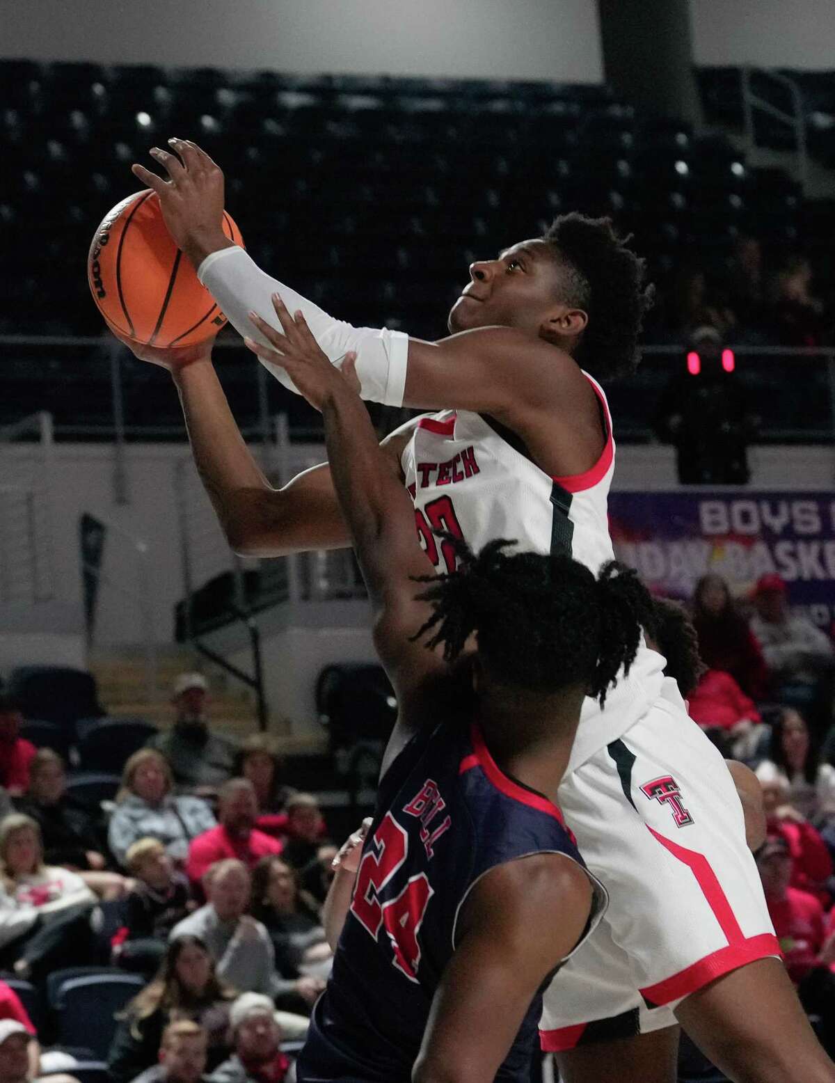 Texas Tech Red Raiders guard Elijah Fisher (22) is fouled by Jackson State Tigers guard Jalani Bell (24) while going for a lay up during the second half of HBCU Roundball Classic hosted by Coaches Vs. Racism game Saturday, Dec. 17, 2022, at Delmar Field House in Houston.
