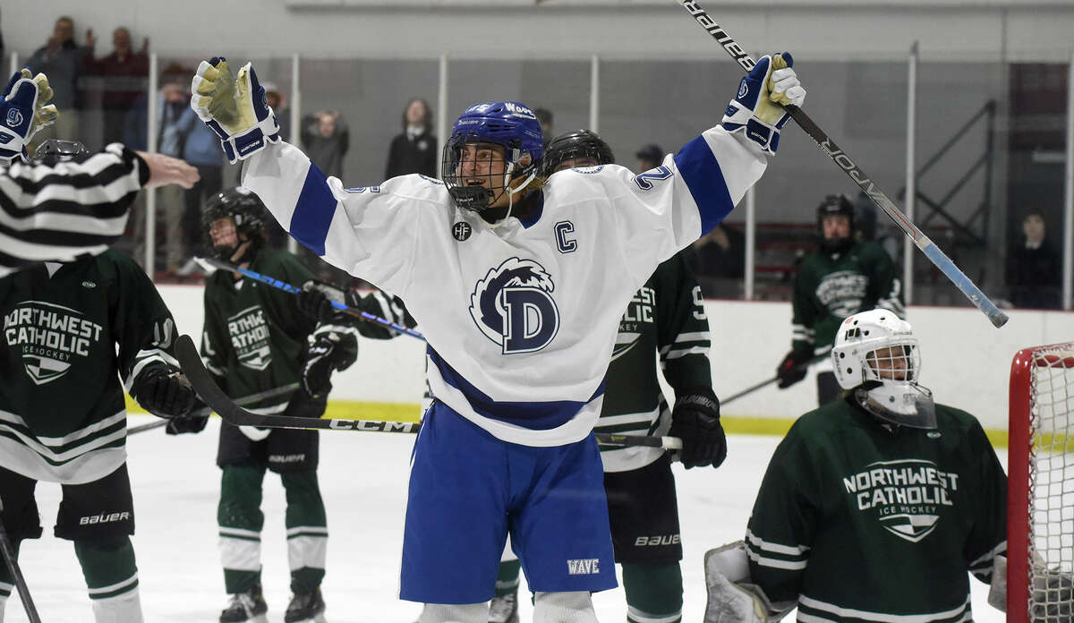 Darien's Tommy Branca (25) celebrates after scoring the winning goal with 2:55 remaining in a boys ice hockey game against Northwest Catholic at the Darien Ice House on Saturday, Dec. 17, 2022.