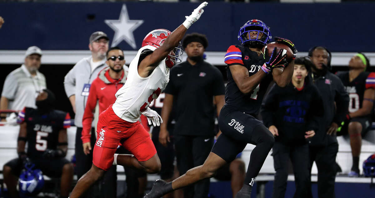 Duncanville wide receiver Dakorian Moore (4) catches a 43-yard pass ahead of North Shore defensive back Jacoby Davis (5) in the first quarter of the Class 6A Division I football state championship at AT&T Stadium, Saturday, Dec. 17, 2022, in Arlington.