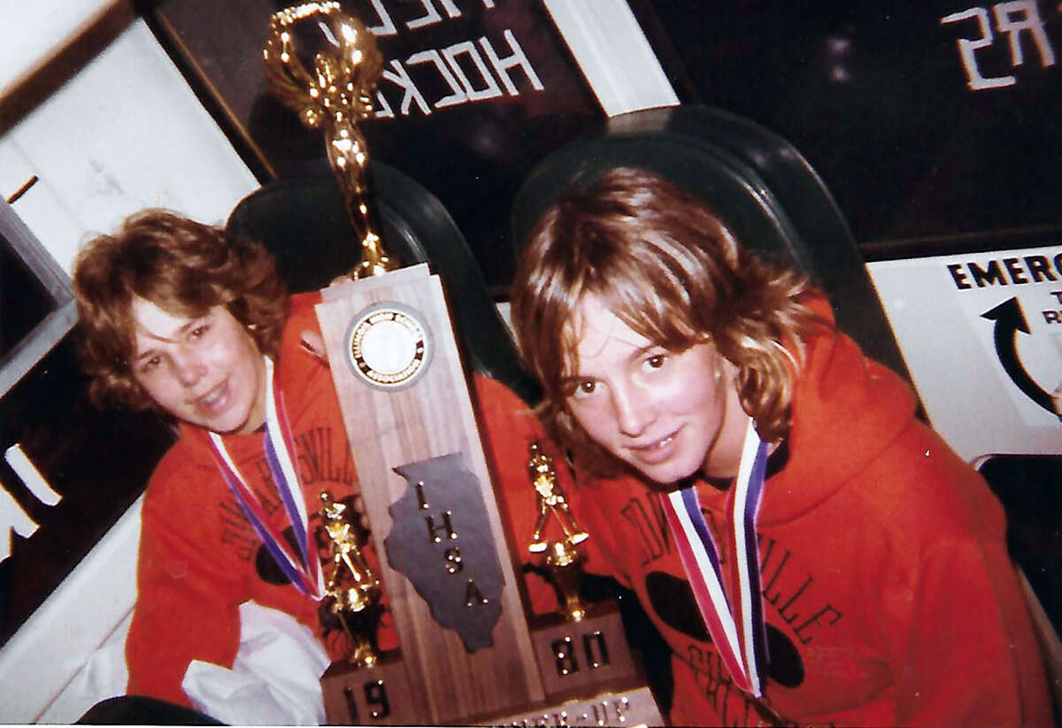 Edwardsville’s Sherree Hoskins, left, with her friend and teammate, the late Iris Schoenleber, on the bus with the state field hockey runner-up trophy in 1980, Hoskins’ junior year.