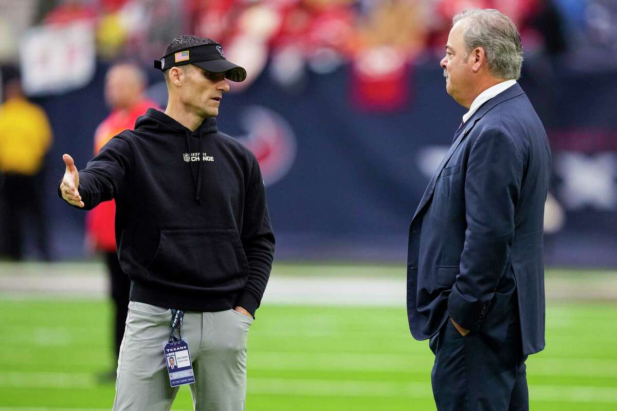 Houston Texans general manager Nick Caserio, left, and CEO Cal McNair talk on the field before an NFL football game against the Kansas City Chiefs Sunday, Dec. 18, 2022, in Houston.