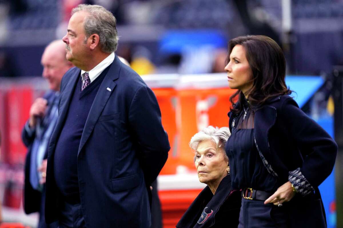 Houston Texans CEO Cal McNair, left, stands on the sidelines with his mother, team co-founder Janice McNair and his wife Hannah, before an NFL football game against the Kansas City Chiefs Sunday, Dec. 18, 2022, in Houston.