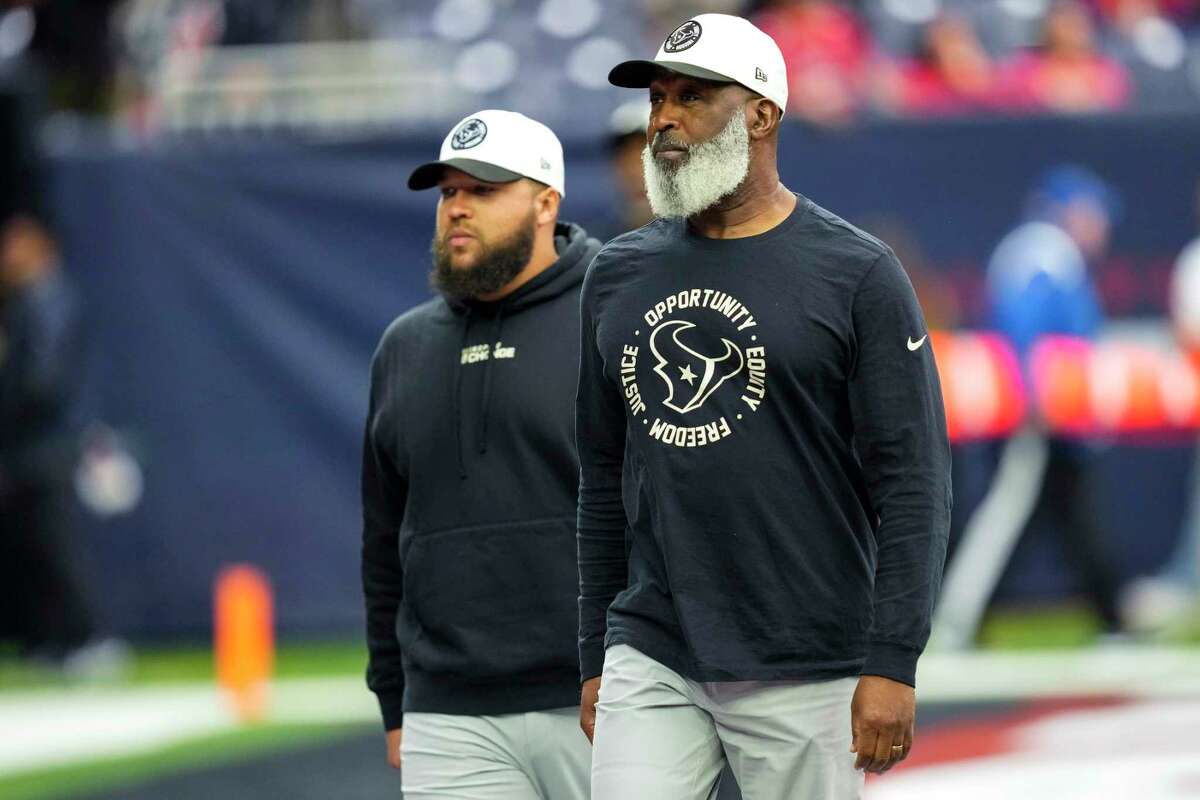 Houston Texans head coach Lovie Smith walks on the field with linebackers coach Miles Smith, before an NFL football game against the Kansas City Chiefs Sunday, Dec. 18, 2022, in Houston.