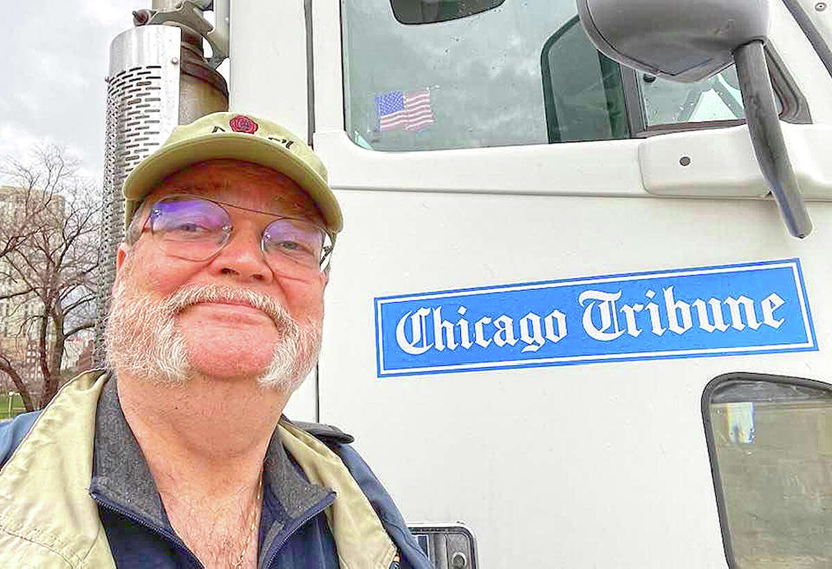 Ray Long stands beside a Chicago Tribune newspaper delivery truck.