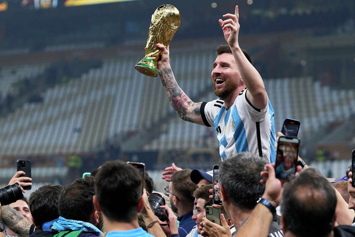 LUSAIL CITY, QATAR - DECEMBER 18: Lionel Messi of Argentina celebrates with the FIFA World Cup Qatar 2022 Winner's Trophy after the team's victory during the FIFA World Cup Qatar 2022 Final match between Argentina and France at Lusail Stadium on December 18, 2022 in Lusail City, Qatar. (Photo by Juan Luis Diaz/Quality Sport Images/Getty Images)