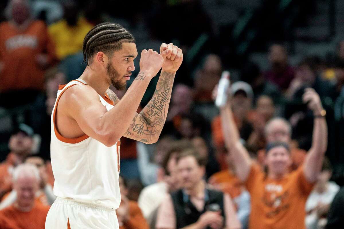 Texas forward Timmy Allen exults in the final seconds of his team's 72-62 win over Stanford in an NCAA college basketball game, Sunday, Dec. 18, 2022, in Dallas. (AP Photo/Jeffrey McWhorter)