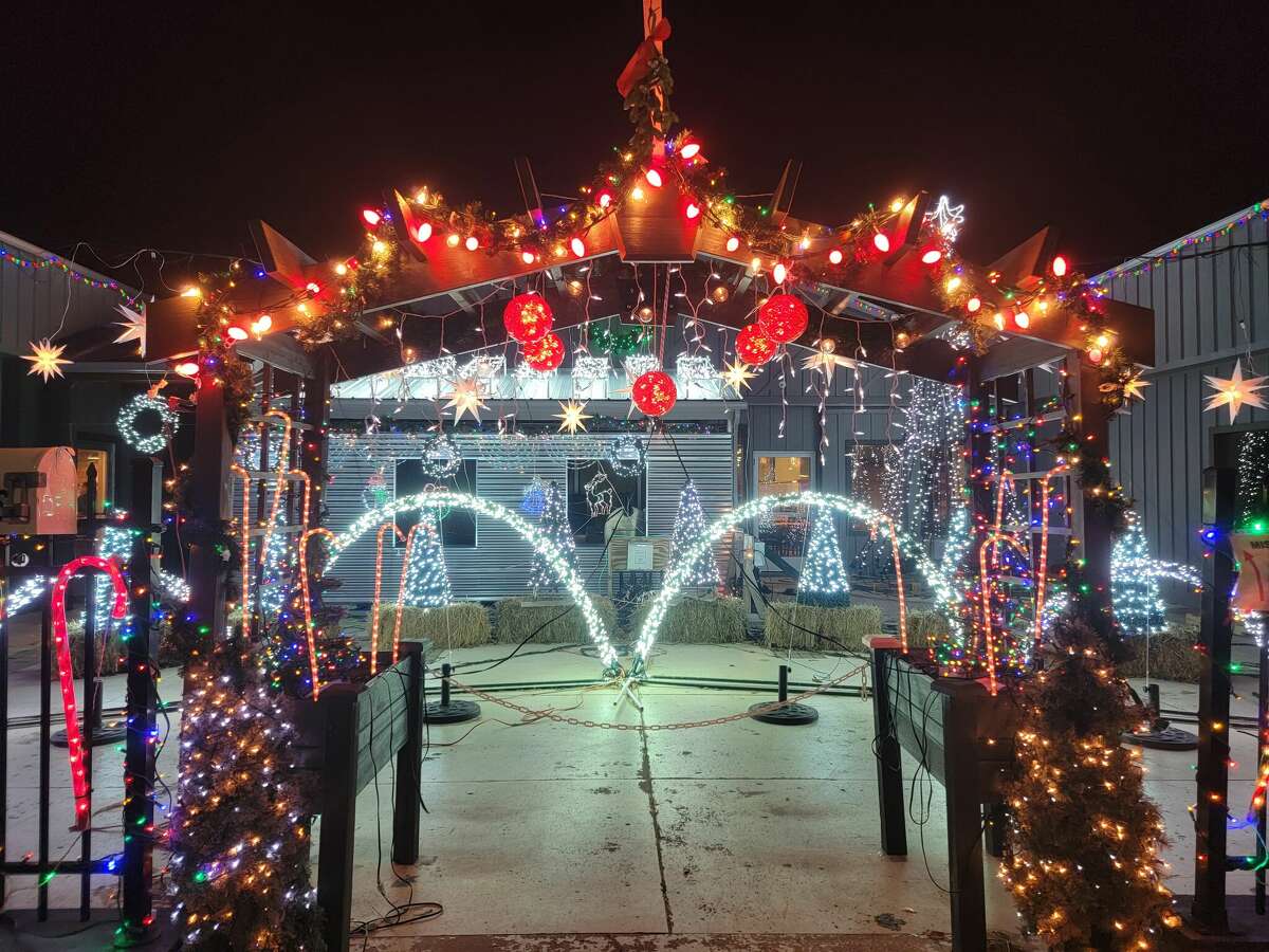 A lighted archway features some mistletoe hanging over the sidewalk to give couples visiting the intricate display a reason to smooch. 