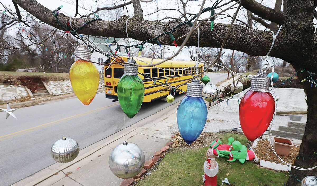 John Badman|The Telegraph A school bus passes by Christmas decorations Monday on Brown Street in Alton. The Riverbend may see a white Christmas this week, with accumulating snow possible on Thursday.