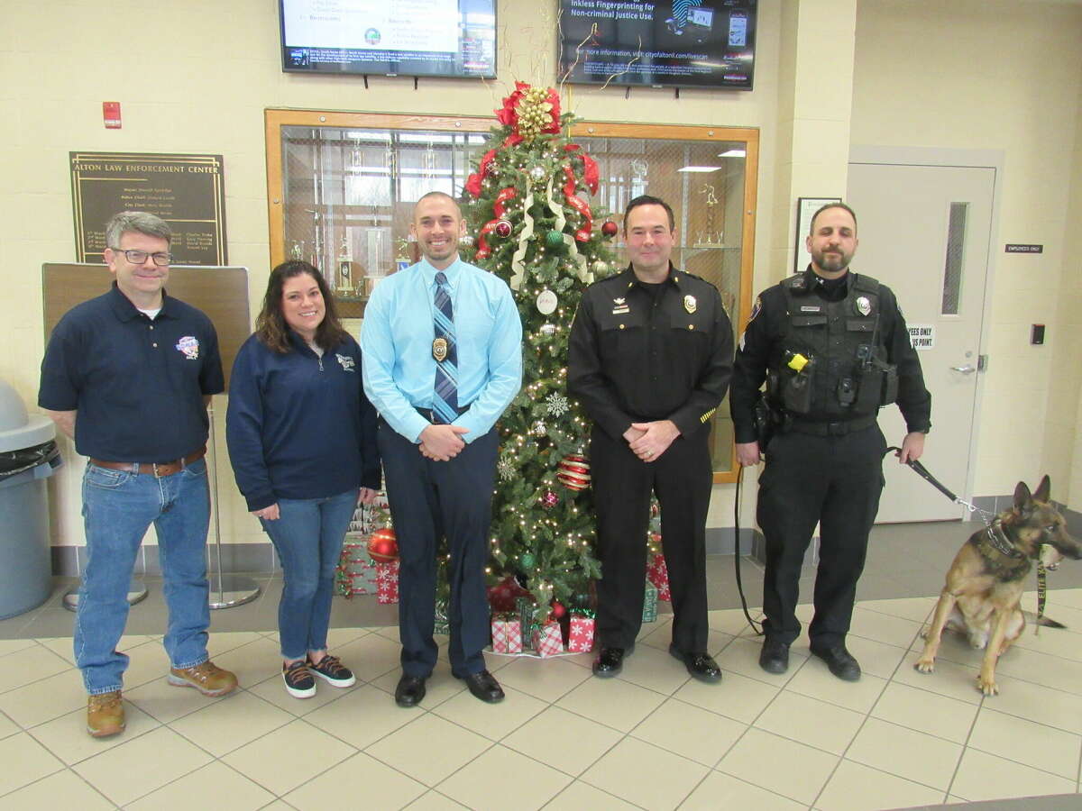 Fast Eddie's is aiding the Alton K9 unit. From left are Fast Eddie's manager Corey Bazzell, co-manager  Danielle McCahil, Alton Police Chief Jarrett Ford, Deputy Chief John Franke, Officer Mike Morelli and K9 Jax.