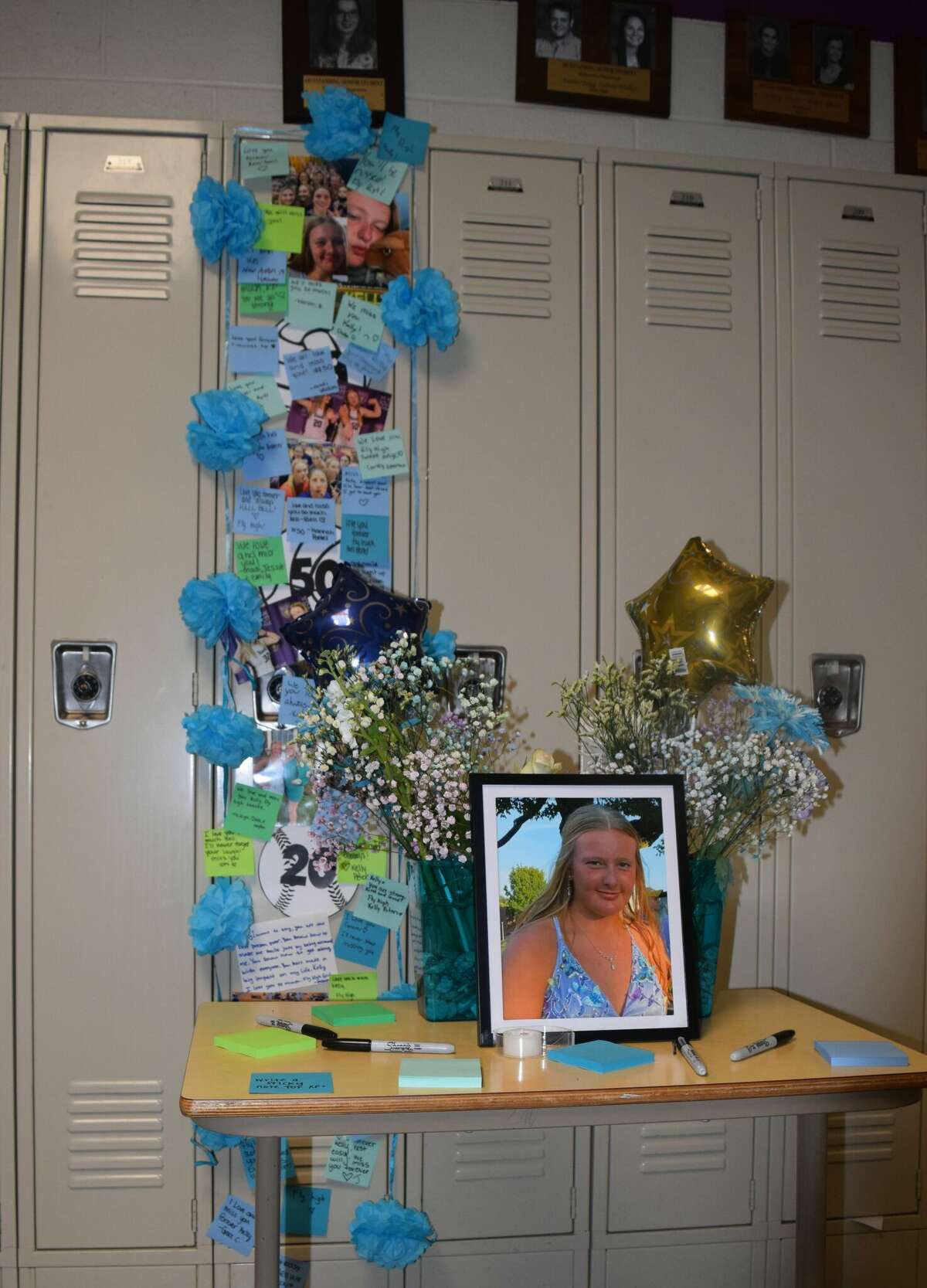 Routt Catholic High School students have left their parting words to junior Kelly Peters, who died Saturday, at a memorial at her locker.