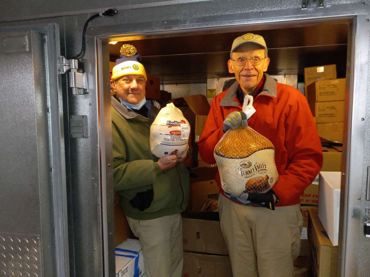 Torrington Winsted Area Rotary Club members  Bill Harding, left, and John Lavieri delivered 100 turkeys and hams to FISH of Northwest CT shelter and food pantry on Monday. 