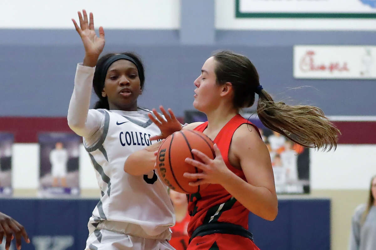 College Park Hannah Moore, left, tries to break up the shot attempt by The Woodlands' Brianna Dickson, right, during their District 13-6A girls basketball game at College Park High School Monday, Dec. 19, 2022 in The Woodlands, TX.