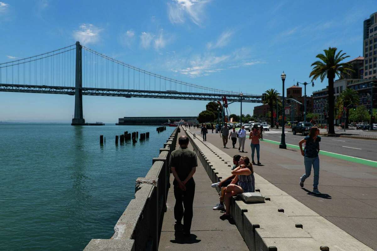 People walk along the Embarcadero in San Francisco, California, on Wednesday, June 12, 2019. A group has proposed closing the iconic boulevard to car traffic.