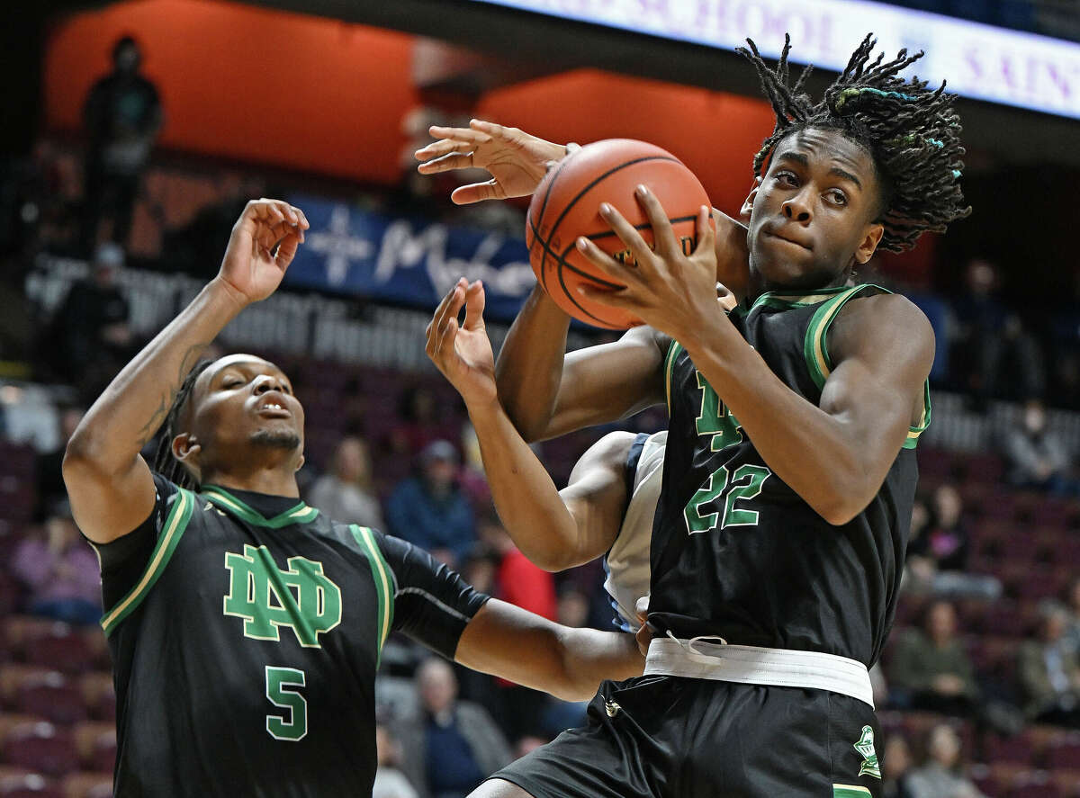 Notre Dame forward Tajae Jones (22) pulls down a rebound against East Catholic in non-league boys high school basketball action Monday, December 19, 2022 at Mohegan Sun Arena. East Catholic came back in the second half for the 62-50 win. (Sean D. Elliot/Special to GameTimeCT)