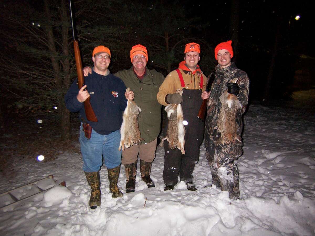 Tom Lounsbury (second from left) and his three sons (from left) Jake, Joe and Josh took a nice bag of cottontails during a Christmas Day family rabbit drive in the Thumb.