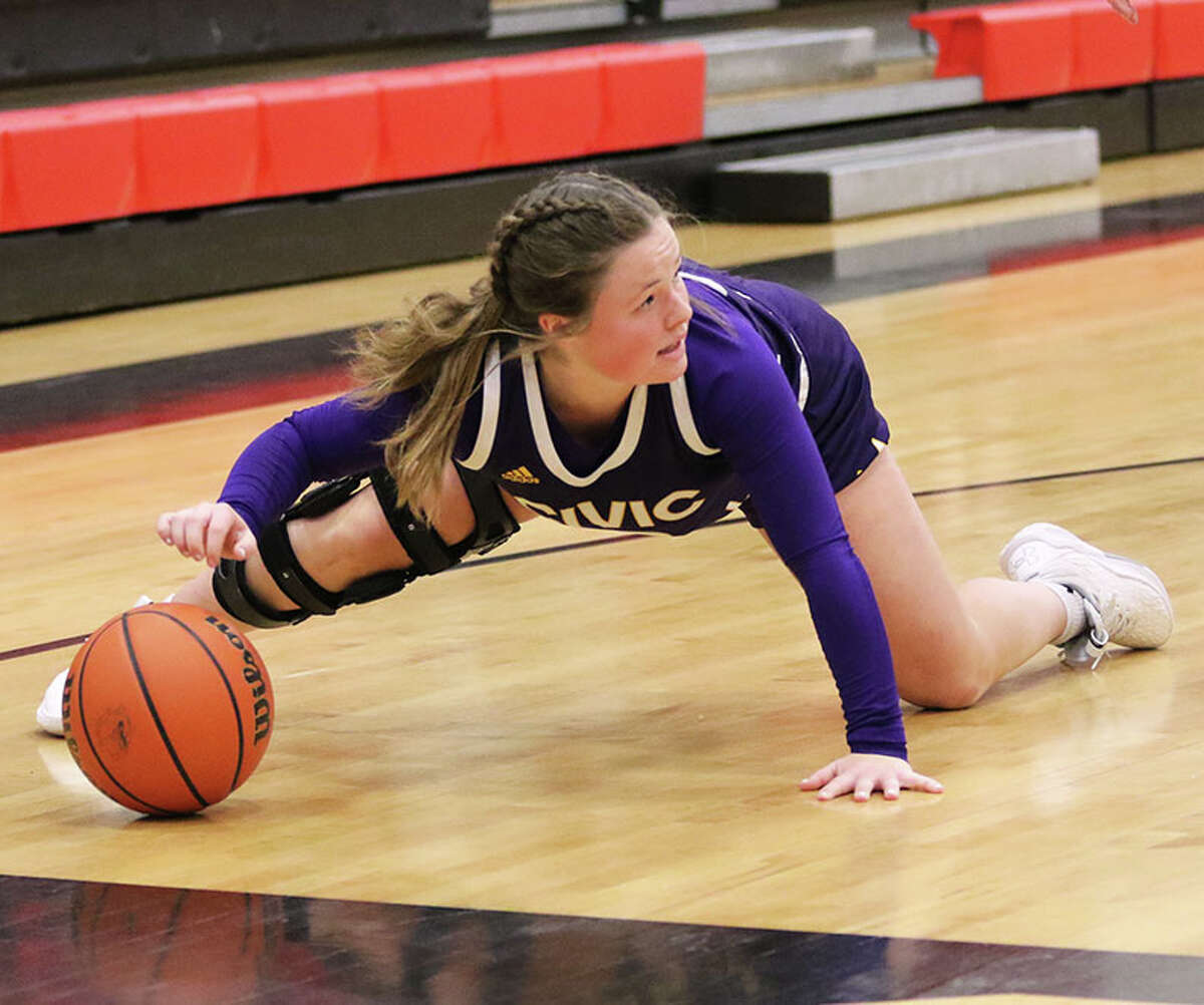CM's Aubree Wallace recovers the loose ball and looks for a teammate after making a steal in the backcourt against the Bulldogs in a MVC girls basketball game on Monday night at Highland.