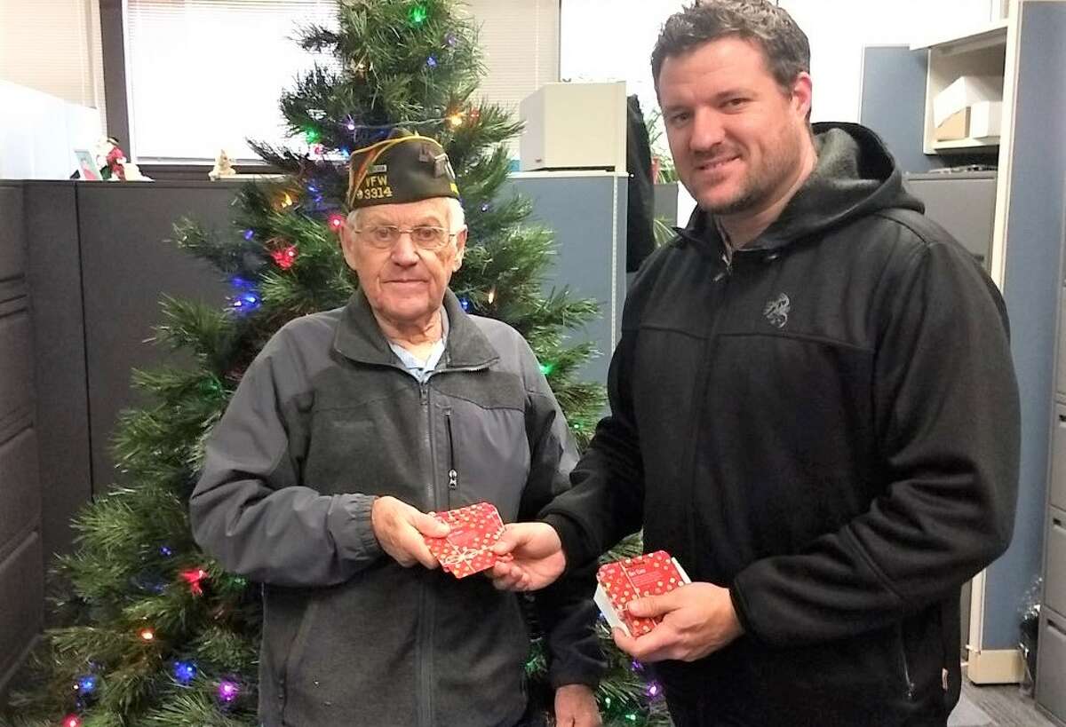 Arcadia VFW Post 3314 quartermaster Keith McArthur (left) presents a donation to Matthew Dotson, community resource coordinator at Benzie-Manistee Michigan Department of Health and Human Services.