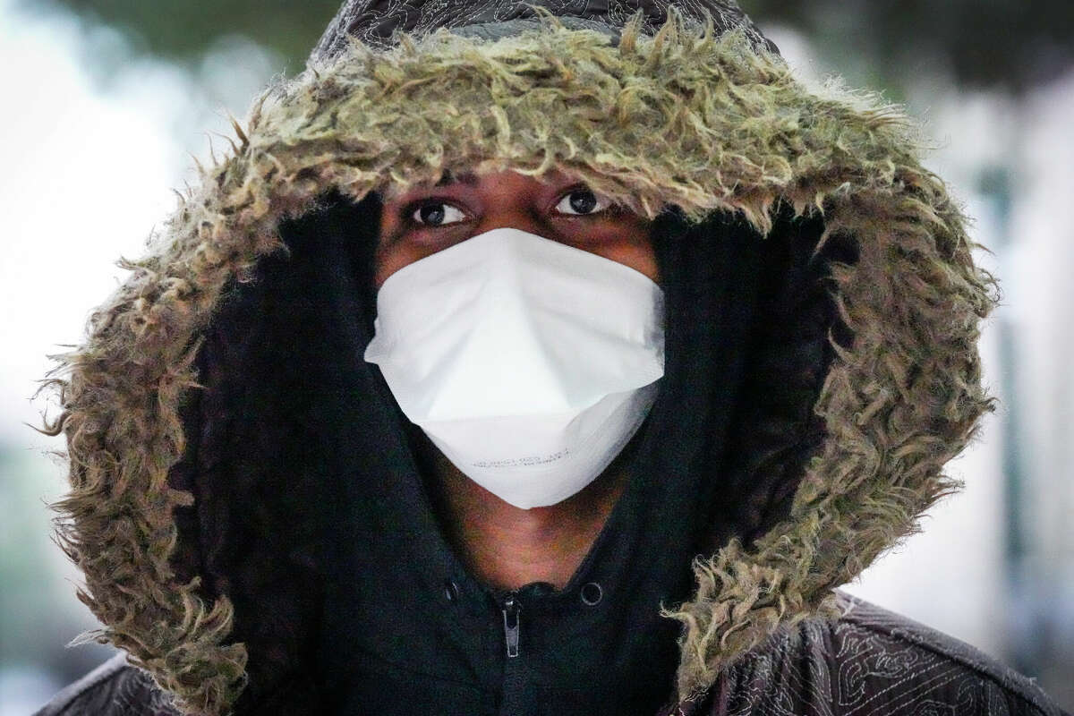LaVontrea Henry King bundles up in the cold as he walks downtown on Monday, Dec. 19, 2022 in Houston. A cold front forecasted to sweep across Texas could plunge temperatures in and around Houston into the 20s or lower, the National Weather Service said. A forecast predicting very cold temperatures on the night of Thursday, Dec. 22 into the following morning. The sub-freezing could last through Christmas Day on Sunday..