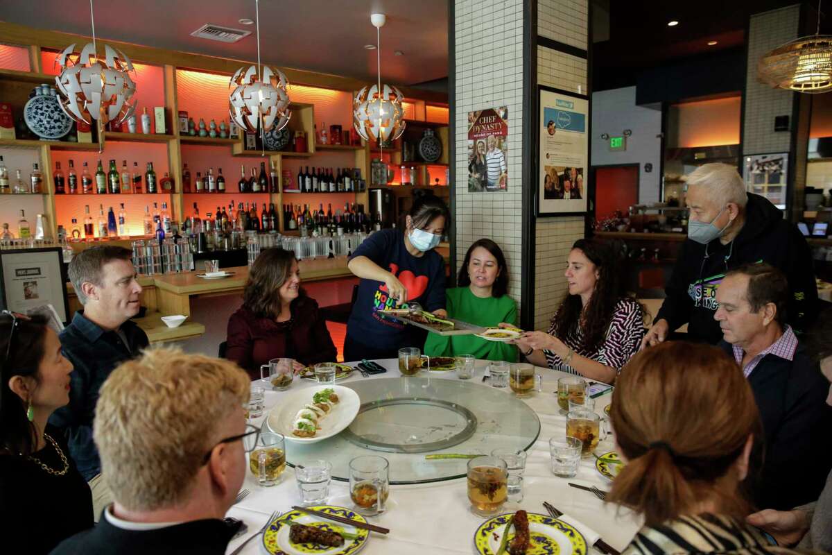 Dani Tan, left, and Peter Fang, right, check on a table of customers enjoying lunch at Fang in San Francisco, Calif., on Wednesday, December 14, 2022. Kathy Fang, daughter of the family behind San Francisco Chinatown classic House of Nanking, stars in a new Food Network docuseries, "House of Fang," which debuts Dec. 27.