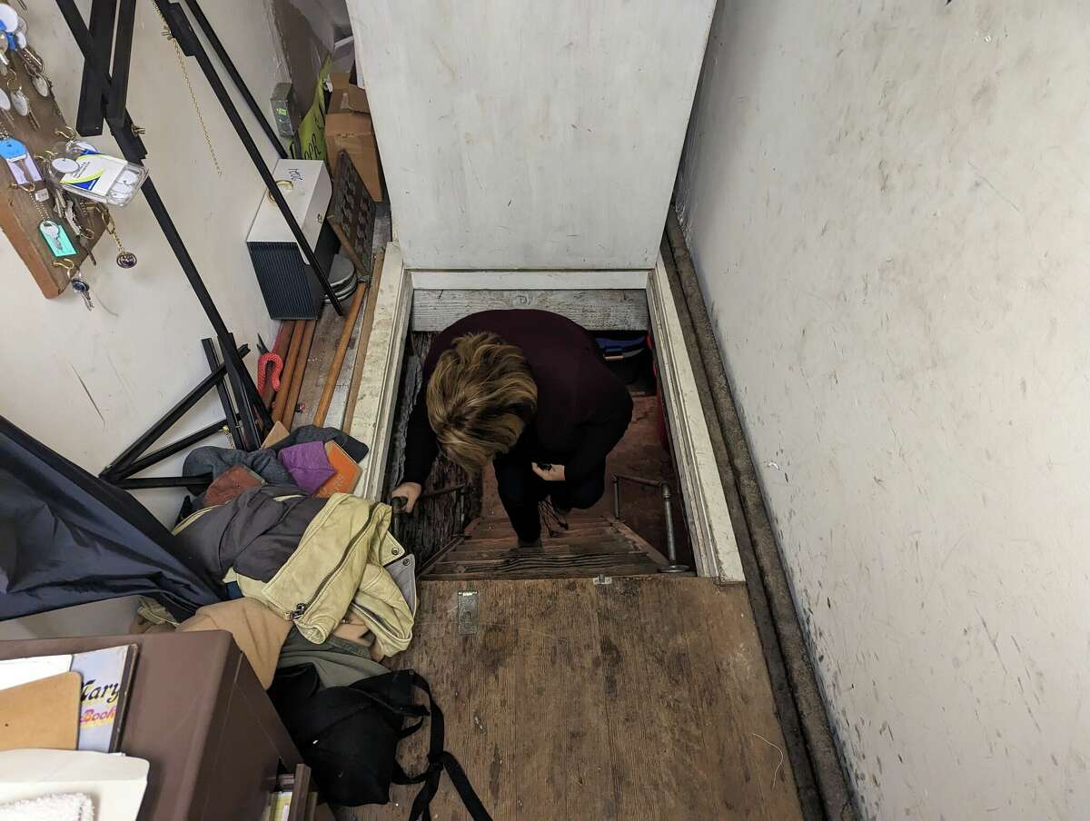 Owner Michele Pelton steps inside one of the many hideaway staircases.
