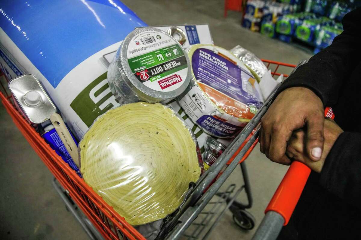 Angel Salazar shops for insulation in preparation for the dropping temperature on Monday, Dec. 19, 2022 in Houston.