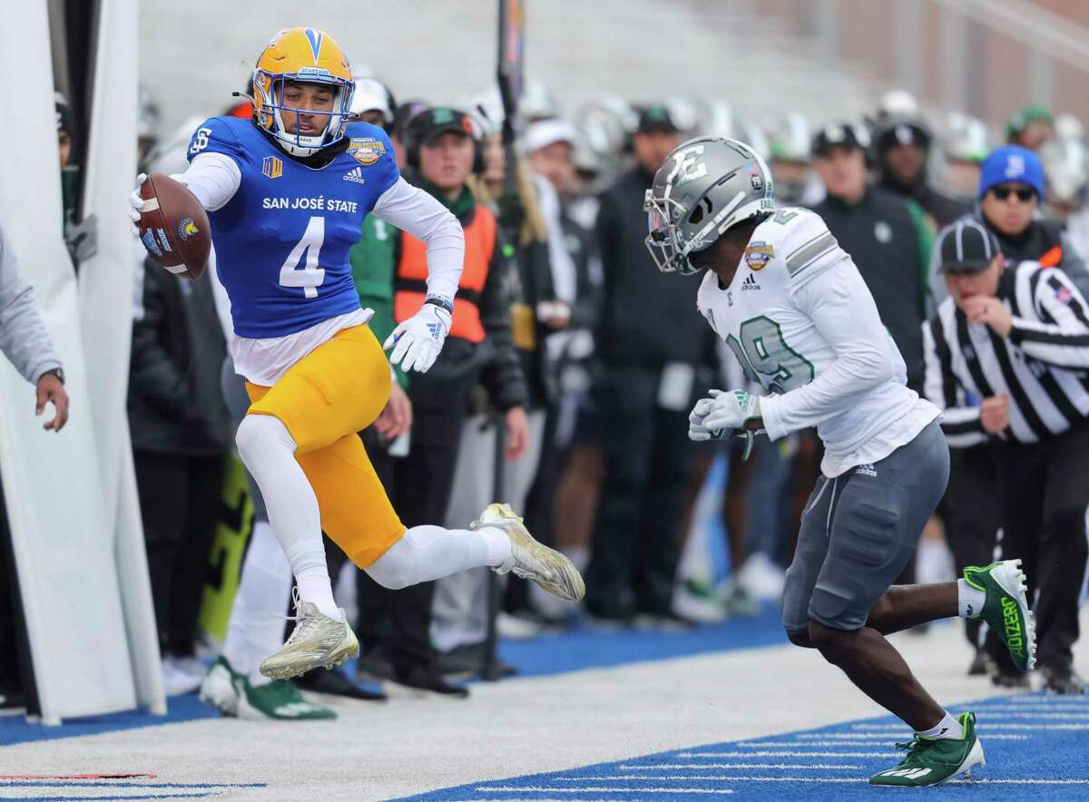 San Jose State wide receiver Elijah Cooks (4) reaches the ball out for a first down after a reception in front of Eastern Michigan defensive back Kempton Shine (29) in the first half of the Idaho Potato Bowl NCAA college football game, Tuesday, Dec. 20, 2022, in Boise, Idaho. (AP Photo/Steve Conner)