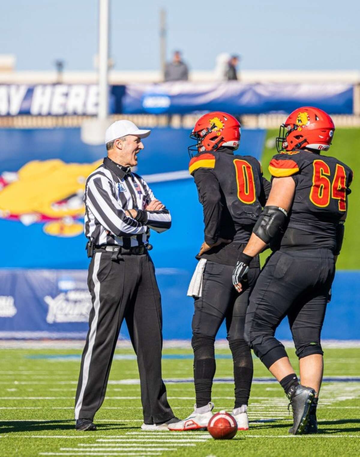 Ferris quarterback Mylik Mitchell (0) and lineman Marouf Hamade talk with an official during the national championship game.