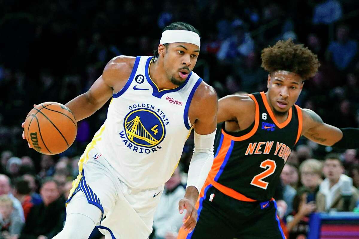 Golden State Warriors' Moses Moody (4) drives past New York Knicks' Miles McBride (2) during the first half of an NBA basketball game Tuesday, Dec. 20, 2022, in New York. (AP Photo/Frank Franklin II)