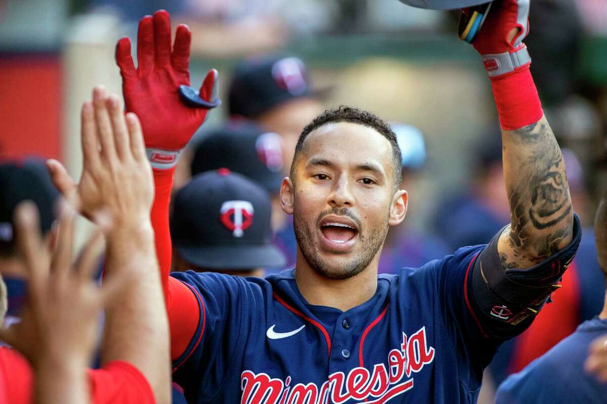 FILE - Minnesota Twins' Carlos Correa, right, is congratulated after hitting a solo home run against the Los Angeles Angels during the first inning of a baseball game in Anaheim, Calif., Saturday, Aug. 13, 2022. In a wild twist overnight, Carlos Correa agreed to a $315 million, 12-year contract with the free-spending New York Mets after his pending deal with the San Francisco Giants came apart over an issue with his physical.
